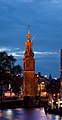 Image 14 Munttoren Photo: Massimo Catarinella The Munttoren, a tower in Amsterdam, the Netherlands, as seen from the river Amstel at dusk. The tower was originally part of the Regulierspoort, one of the main gates in Amsterdam's medieval city wall, dating to 1487. After a fire destroyed the gate in 1618, the tower was rebuilt in the Amsterdam Renaissance style, with an eight-sided top half and open spire designed by Hendrick de Keyser, featuring a clock with four faces and a carillon of bells. The name ("Mint Tower") refers to the time when it was temporarily used to mint coins in the Rampjaar ("disastrous year") of 1672 when both England and France declared war on the Dutch Republic, and silver and gold could not be safely transported to Dordrecht and Enkhuizen, where coins were normally minted. More selected pictures