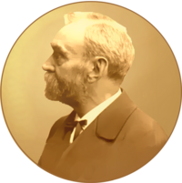 A golden medallion with an embossed image of Alfred Nobel facing left in profile. To the left of the man is the text "ALFR•" then "NOBEL", and on the right, the text (smaller) "NAT•" then "MDCCCXXXIII" above, followed by (smaller) "OB•" then "MDCCCXCVI" below.