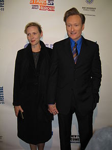 A picture of Conan O'Brien to the right and his wife to the left