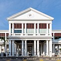 Front façade of a white Palladian-style courthouse prominently featuring columns supporting the pediment and entablature.