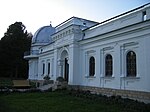 An astronomical observatory tower and surrounding buildings