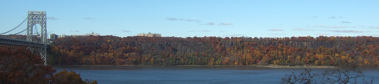 Pictured the The Palisades, with the George Washington Bridge on the left. The Palisades are a line of steep cliffs along the west side of the Hudson River in Northeastern New Jersey and Southeastern New York, stretching north from Jersey City, New Jersey to Nyack, New York.