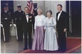 President George H. W. Bush and First Lady Barbara Bush with Queen Elizabeth II and Prince Philip, Duke of Edinburgh at the beginning of an official dinner at the White House, 1991.