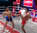 Intercepting a kick in Cambodian boxing match