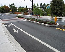 Median island with a raised mid-block pedestrian crossing