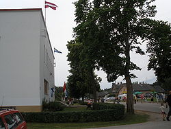 Livonian culture centre in Mazirbe with flags on display during annual meeting.