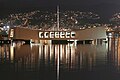 USS Arizona Memorial is bathed by the lights of ‘Aiea on the evening of the 62nd anniversary of the attack on Pearl Harbor, December 7, 2003.