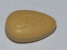 A tan teardrop-shaped tablet with C20 engraved on it.