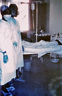 Àrùn kòkòrò àìlèfojúrí afàìsàn Ebola1976 àwòrán àwọn nọ́ọ̀sì méjì tó dúró síwájú Mayinga N., ẹnití ó ní àrùn kòkòrò àìlèfojúrì afàìsàn Ebola; ó kú lẹ́yìn ọjọ́ díẹ̀ sí àsìkò náà nítorí ọ̀pọ̀lọpọ̀ ẹ̀jẹ̀ sísun láti inú wá.