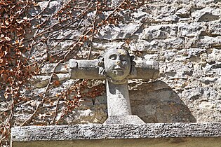 Visage sculpté sur une croix du portail.