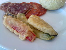 Pieces of bell pepper in a thin bubbly batter