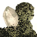 Black babingtonite which covers a matrix of botryoidal, green prehnite, and a large, colorless, doubly terminated quartz crystal