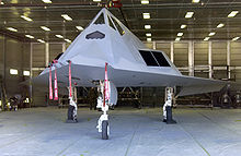 Aircraft parked inside an open hangar