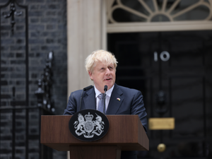 Johnson outside 10 Downing Street, standing at a wooden lectern