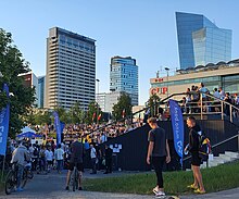 Downtown spectators, on foot and on bicycles