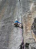 A climber doing the laybacking technique