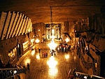 Underground hall from above, chandeliers and tourists