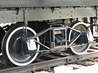 An archbar-type truck with American style journal boxes that are bolted to ends of the side frame