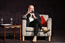 Paul Gascoigne speaking into a microphone