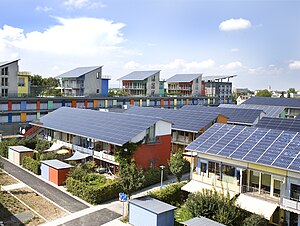 Blocks of houses with roofs completely covered in solar panels.