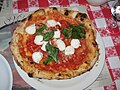 Image 33Traditional pizza Margherita, whose ingredients, tomato (red), mozzarella (white) and basil (green), are inspired by the colours of the national flag of Italy. (from Culture of Italy)