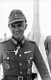 A man wearing a military uniform with various military decorations.