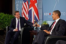 US President Barack Obama and British Prime Minister David Cameron exchange bottles of beer to settle a bet they made on the US vs. England World Cup football match (which ended in a draw), during a bilateral meeting at the G20 Summit in Toronto, Canada, Saturday, 26 June 2010