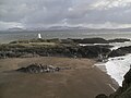 Llanddwyn Island old lighthouse with Gwynedd in background.