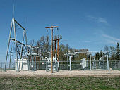 An image of an unconcealed substation in Warren, Minnesota with many metal parts fenced off in an open field