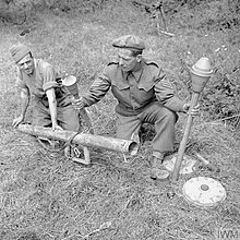 Two soldiers of the 59th Division pose with German anti-tank weapons