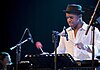 Man in black hat and white shirt playing the vibraphone