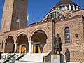 The entrance of the church with a statue of Constantine XI Palaiologos