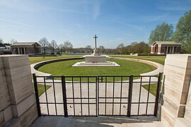 Hooge Crater Cemetery entrance with Cross of Sacrifice and the stone-faced circle designed by Sir Edwin Lutyens in memory of the many craters nearby