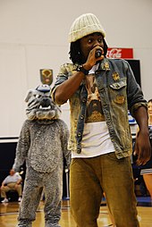 Wale rapping on stage.