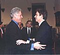 President Bill Clinton and Prime Minister Tony Blair embracing each other at a conference in Florence, Italy, 1999.