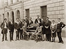 outdoor group photograph of a small class of students with their professor