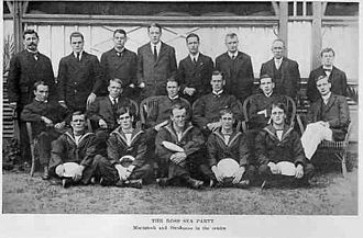 A group of 19 men arranged in three rows, many of them in naval uniforms