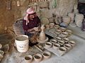 Image 27An artisan making pottery using the traditional mud and water mixture on a revolving wheel. (from Bahrain)