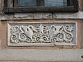 Carving on a house façade in the centre of the village