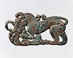 Belt plaque in the shape of a standing wolf, characteristic of nomadic artifacts of southern Ningxia and southeastern Gansu, and related to the Scythian styles of Pazyryk. 4th century BC.[108][104]