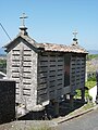 A Latin cross and a Celtic cross atop a Galician hórreo (granary)