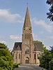 De R.K. St. Plechelmuskerk staat op het omgrachte terrein van het voormalige kasteel van Saasveld. Een ijzeren ophaalbrug leidt over de gracht naar het terrein en de kerk. Rechts (Z) van de kerk is een begraafplaats, aan de achterzijde een parkachtige aanleg.