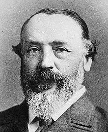 Headshot of middle-aged white man with greying beard and moustache