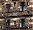 Facade of an old tenement house with figurines of Holy Mary