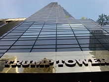 a view upward toward the top of the Trump Tower, a 58-floor building with a brown-glassed façade