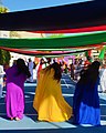 Image 2Women flip their hair sideways and wear brightly coloured traditional dress while performing an Emirati folk dance. (from Culture of the United Arab Emirates)