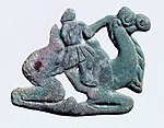 Nomadic figure, typically with a long nose, on a Bactrian camel. Southern Ningxia, 4th century BC.[106][104]