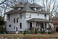 Image 4A wood-frame American Foursquare house in Minnesota with dormer windows on each side and a large front porch