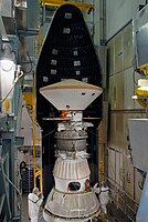 On Launch Pad 17-A at Cape Canaveral Air Force Station, the first half of the fairing is moved into place around the Phoenix Mars Lander for installation. The grey sphere is the PAM-D solid rocket that gave Phoenix the final velocity for the Martian cruise.