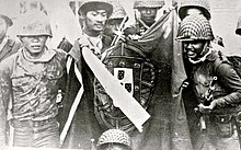 Soldiers holding a Portuguese flag